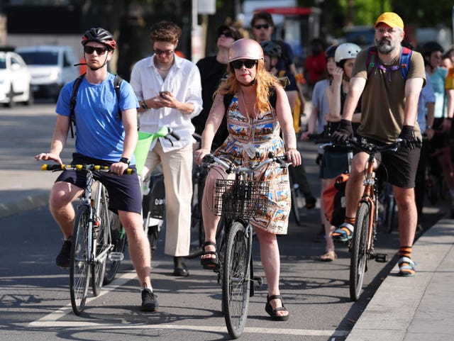 Cyclists waiting at traffic lights along the Victoria Embankment near Westminster Bridge
