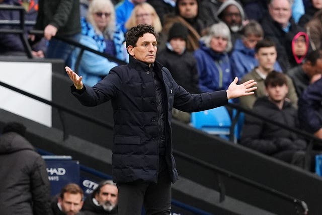 Brentford boss Keith Andrews geatures with his arms spread wide on the touchline at the Etihad Stadium