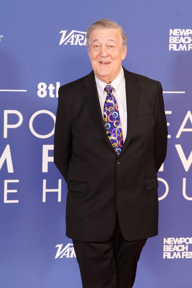 Sir Stephen Fry smiling at red carpet event