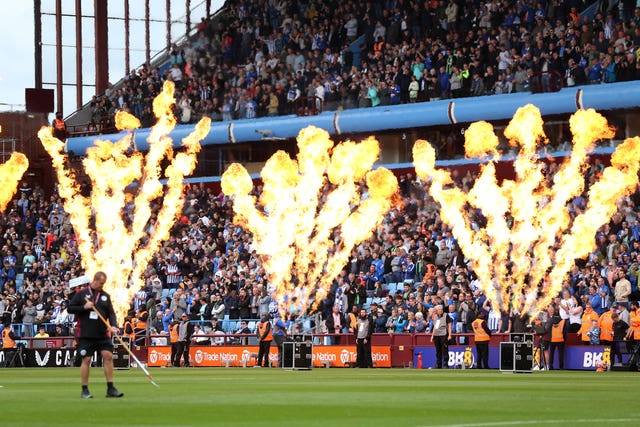 Pyrotechnics are set off as Aston Villa and Brighton make their way onto the pitch at Villa Park