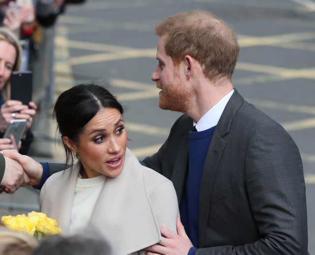 RPrince Harry and Meghan Markle react to wellwishers  (Brian Lawless/PA)