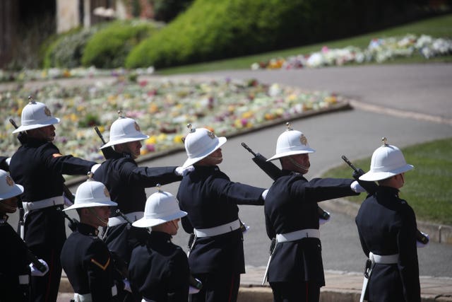 Members of the Royal Marines line the route of the procession