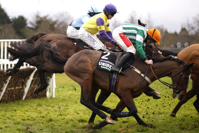 Authorised Speed ridden by jockey Jamie Moore almost falling to the ground but successfully staying on their feet in the Unibet Tolworth Novices’ Hurdle at Sandown Park 