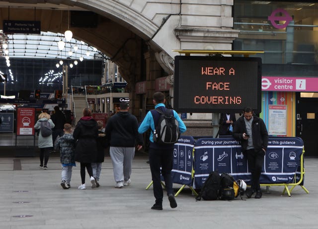A sign to promote the wearing of face coverings at Victoria station (Luciana Guerra/PA)