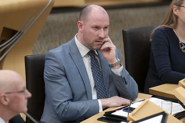 Neil Gray seated in Holyrood