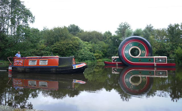 A canal boat passes the new sculpture after it was installed on the Sheffield & Tinsley Canal