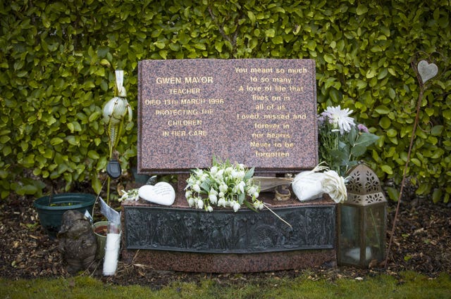 Flowers are laid on a memorial stones for Dunblane teacher Gwen Mayor