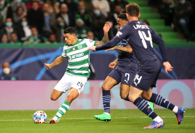 Sporting Lisbon’s Pedro Porro (left) attempts a shot on goal during the UEFA Champions League 