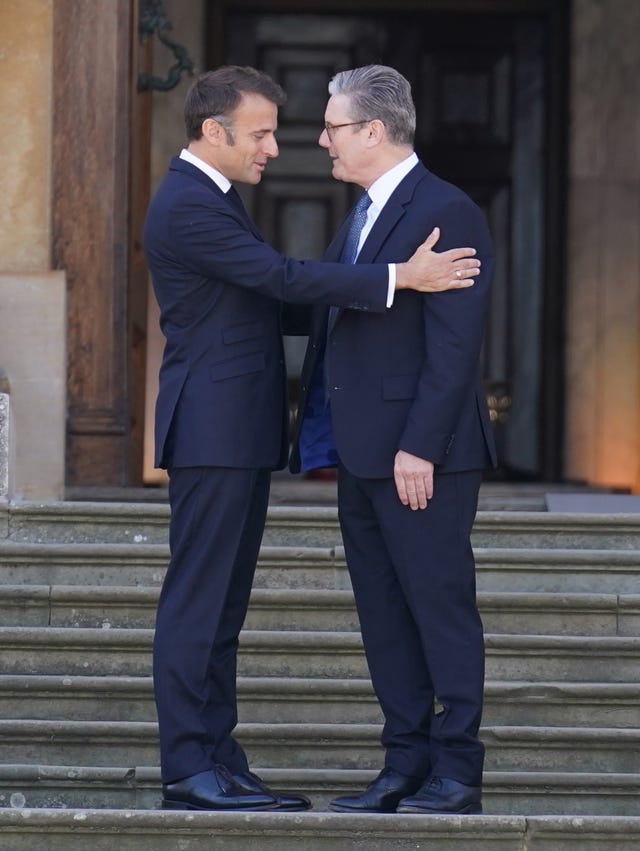 President of France Emmanuel Macron is welcomed by Prime Minister Sir Keir Starmer to the European Political Community summit at Blenheim Palace