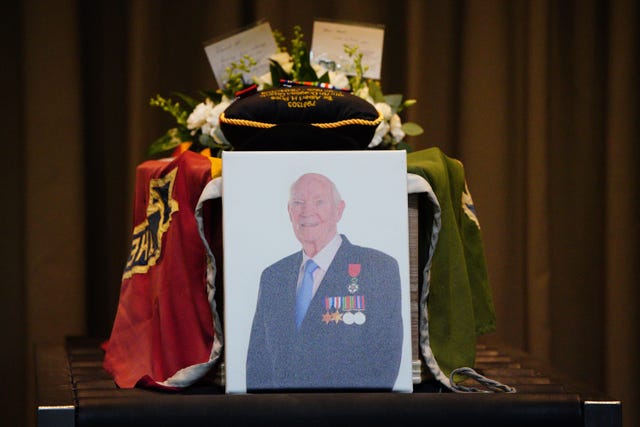 A portrait beside the coffin of D-Day veteran Albert Price, 98, from Solihull. 