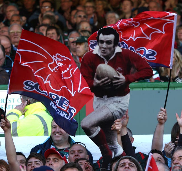 Scarlets fans hold up a cardboard cut-out of Phil Bennett 
