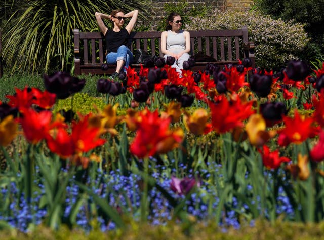 Visitors to Holland Park, London, enjoy the sunshine