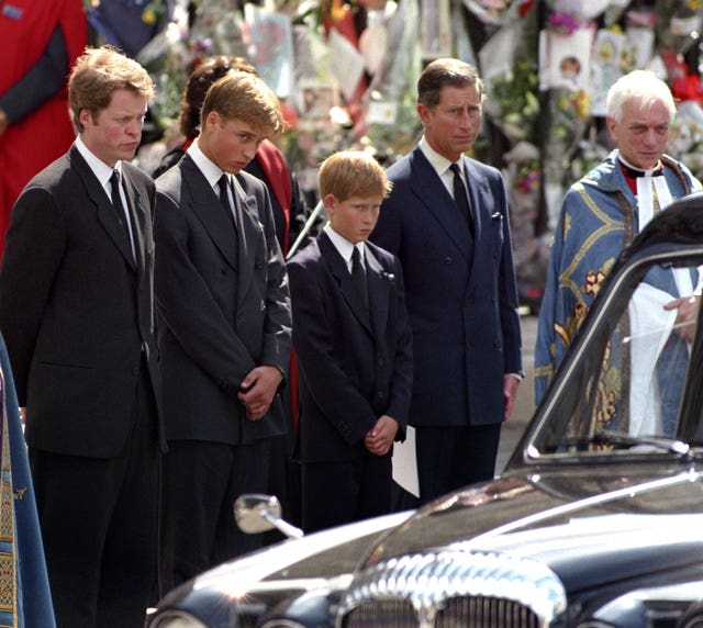 File photo dated 06/09/97 of (left-right) the Earl Spencer, Prince William, , Prince Harry, the Prince of Wales, wait as the hearse carrying the coffin of Diana, Princess of Wales prepares to leave Westminster Abbey in London, following her funeral service