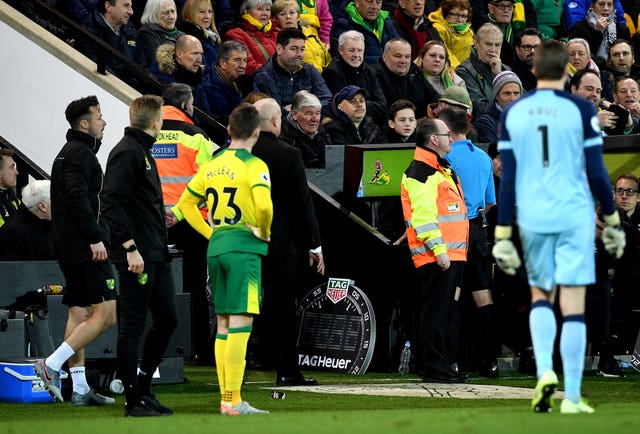 Referee Paul Tierney consults the pitchside monitor before changing Norwich's Ben Godfrey's card from a yellow to a red during the Premier League match against Bournemouth