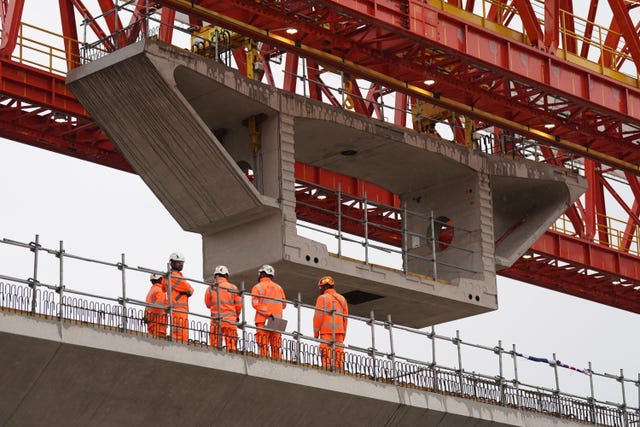 The final deck segment is lowered into place