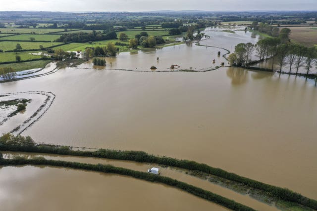 Aerial view of a van stuck in flood water near Buckingham as Storm Alex brought heavy rain (Steve Parsons/PA).