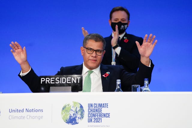 Alok Sharma President of the Cop26 climate summit, raises his hands after his speech of the closing plenary