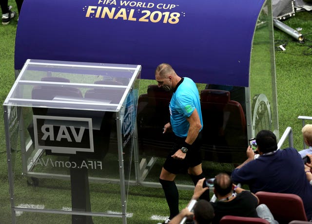 Referee Nestor Pitana studies the video screen during the World Cup final in July