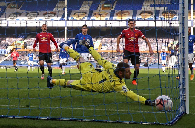 Manchester United goalkeeper David De Gea dives in vain to try and keep out Bernard's shot