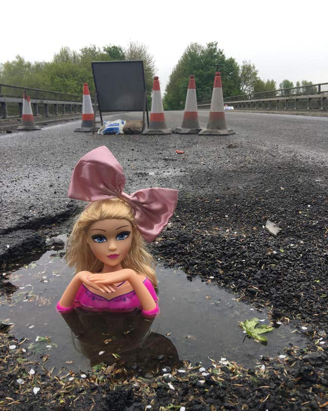 A doll's head in a pothole on Mill Lane, Swindon (Neville Daytona/PA)