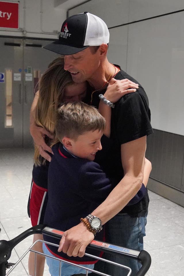 British mountaineer Kenton Cool is greeted by his son Willoughby and daughter Saffron at Heathrow Airport