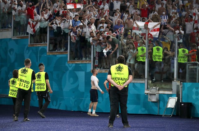 Luke Shaw gives his England shirt to a fan in the stands at the Stadio Olimpico