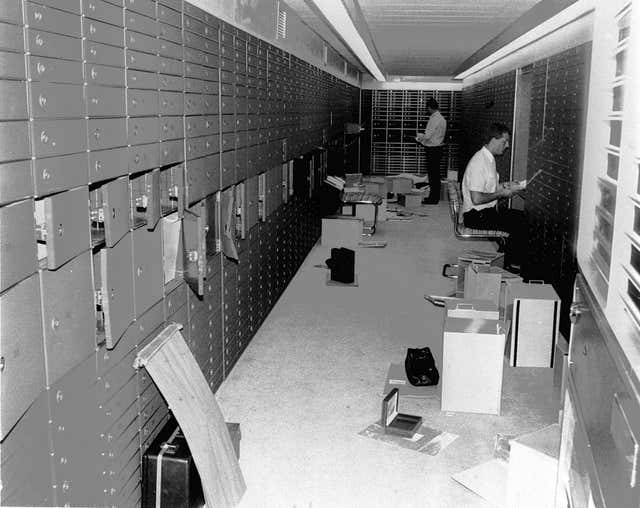 Police officers check the raided boxes in the vault of the Knightsbridge Safe Deposit Centre in 1987 