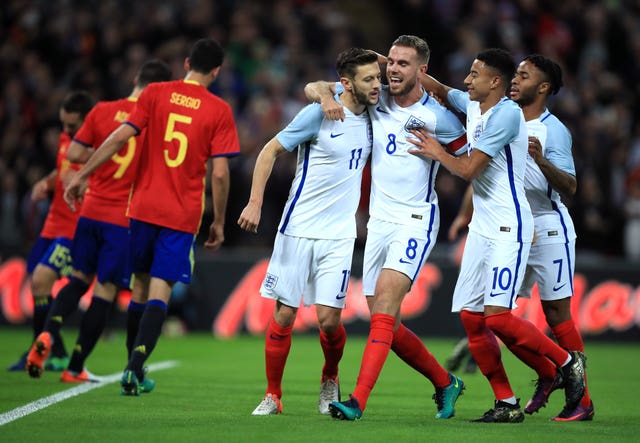 Adam Lallana, left, celebrates after opening the scoring against Spain