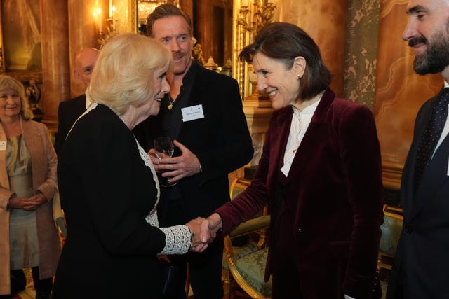 The Queen and Dame Harriet shake hands during a charity reception at Buckingham Palace