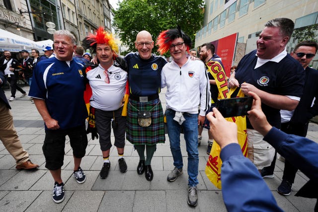 First Minister of Scotland John Swinney poses for photos with fans in Munich
