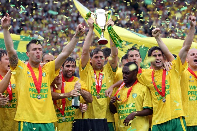 Former Norwich captain Grant Holt (centre) lifts the npower Promotion Trophy