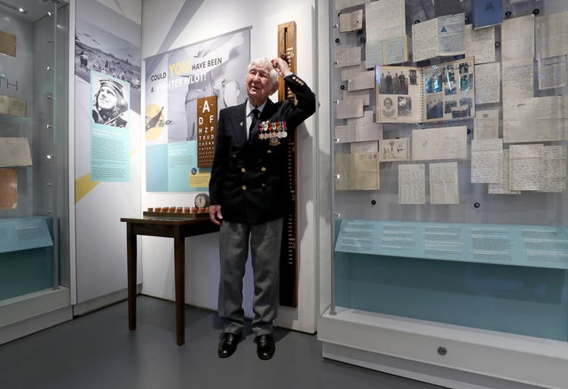 Veteran Peter Lemon checks his height on a fighter pilot exhibit