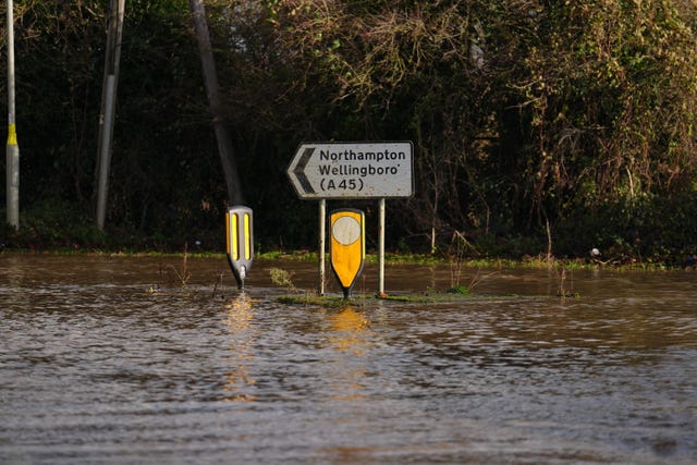 A road sign sticks out from a road 