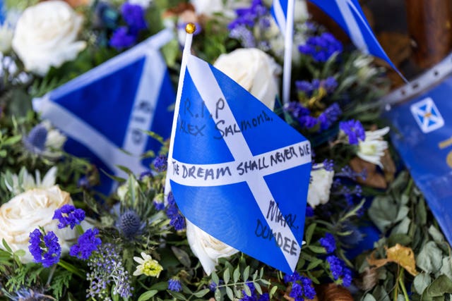 Tributes outside the Scottish Parliament building in Edinburgh, ahead of a Motion of Condolence for the former first minister Alex Salmond