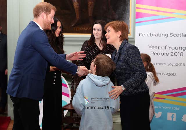 Prince Harry and Meghan Markle meet First Minister Nicola Sturgeon during a reception for young people at the Palace of Holyroodhouse in Edinburgh (Andrew Milligan/PA)