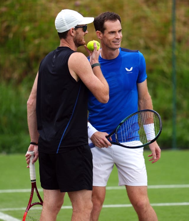 Andy, right, and Jamie Murray talk during practice