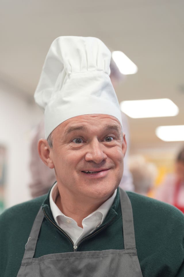 Liberal Democrats leader Sir Ed Davey taking part in a baking lesson with students from High Beeches Primary School during a half-term holiday camp in Hertfordshire 