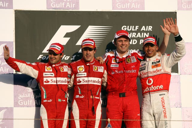 Ferrari’s Fernando Alonso (2nd left), Felipe Massa (left) and team principle Stefano Domenicali pose alongside McLaren’s Lewis Hamilton after the Gulf Air Bahrain Grand Prix