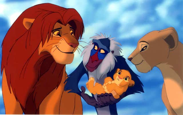 Rafiki holds Simba and Nala's cub