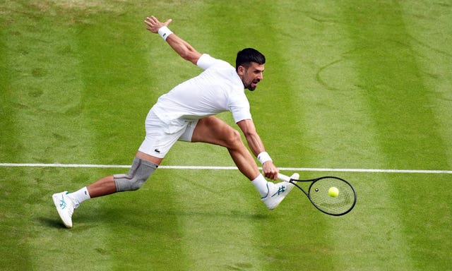 Novak Djokovic stretches to hit a backhand