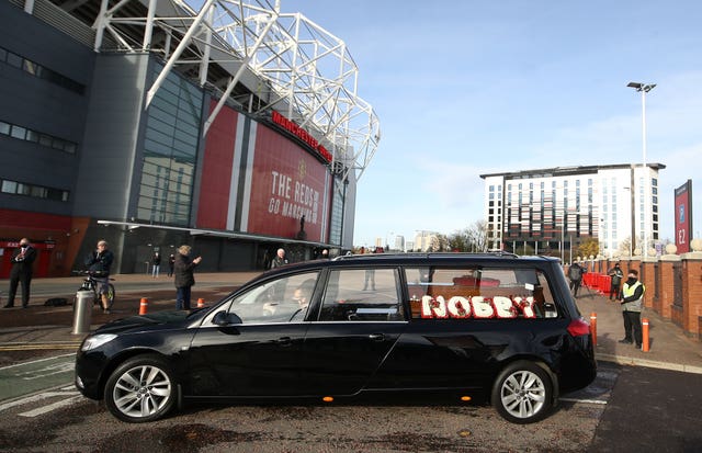 The hearse made its way  past Old Trafford before the service at Manchester Crematorium Southern Cemetery