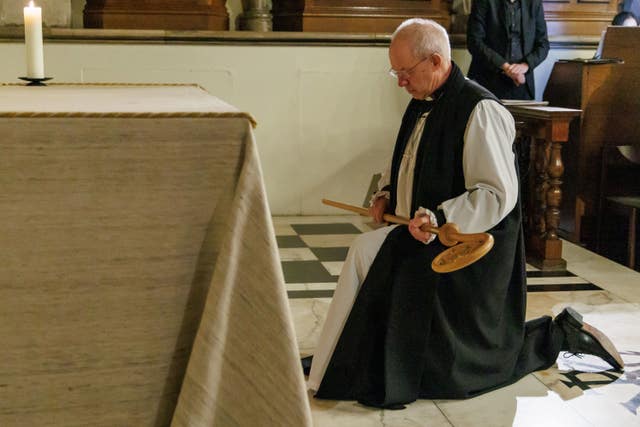 Mr Welby kneeling with the crozier in hand