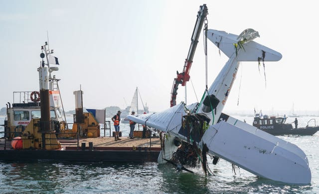 The bi-plane is lifted from Poole harbour following the crash (Andrew Matthews/PA)