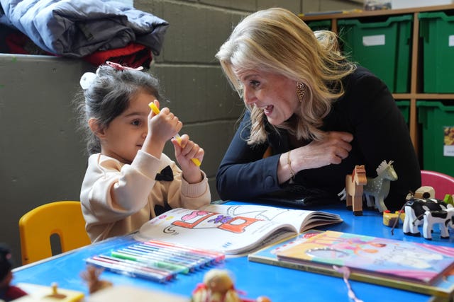 The Duchess of Edinburgh sits next to and chats to a little girl who is colouring while her mother attends the Mothers’ Union’s English for Women session in Chelmsford, Essex 