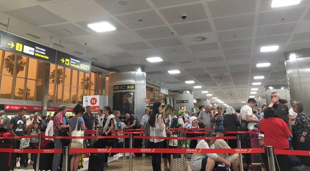 Passengers queue at Tenerife South airport