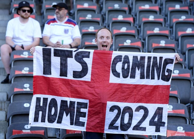 England fans put up their flags inside the stadium