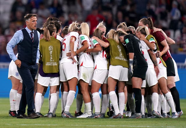 Neville, left, and the players during a huddle