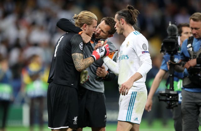 Loris Karius is consoled by Liverpool goalkeeping coach John Achterberg, centre, and Gareth Bale