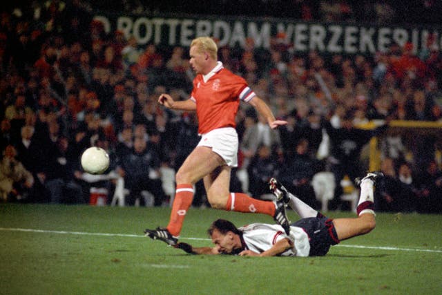 England midfielder David Platt lies face down on the ground as Netherlands defender Ronald Koeman clears the ball