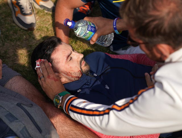 An injured fan is treated for a head wound